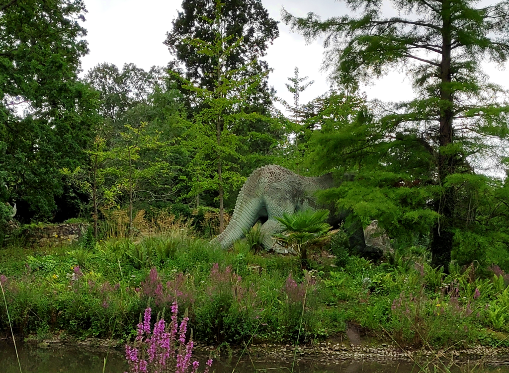 A photograph of the standing Iguanodon from a different angle, showing its mostly-visible backside.