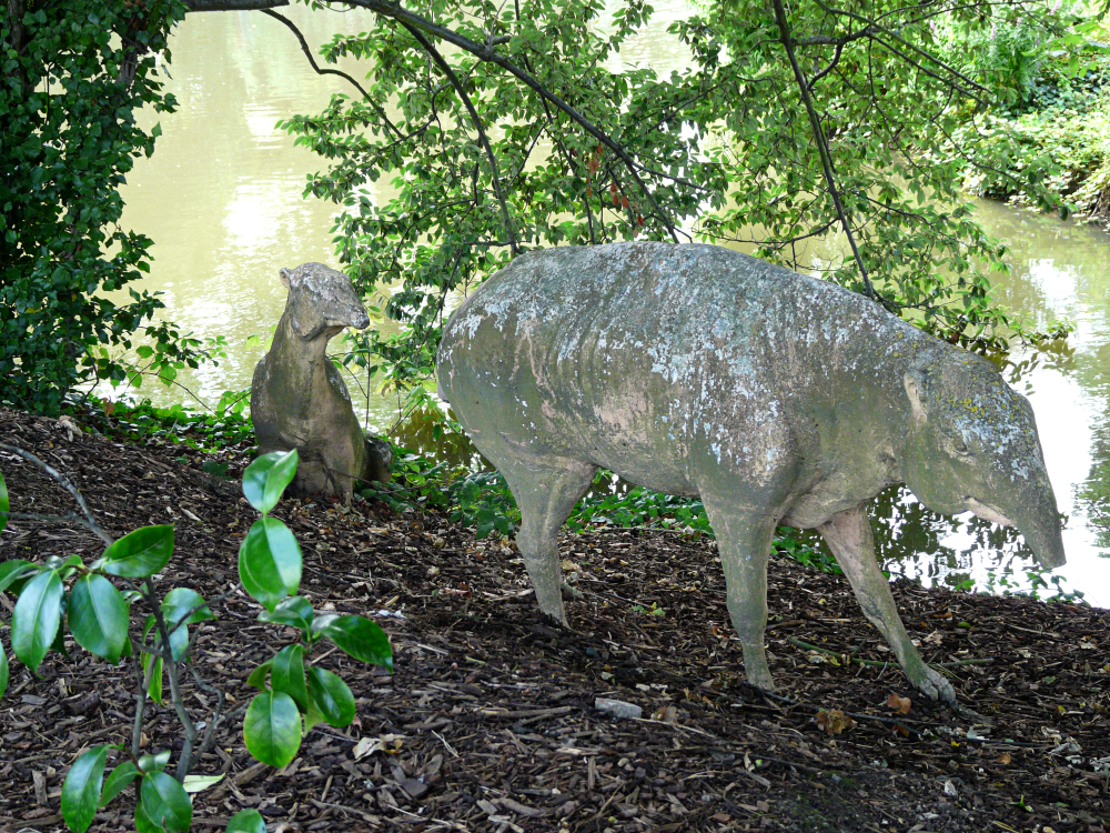 A photograph of the Crystal Palace palaeotheres, depicted as tapir-like animals. A smaller one on the left is in a sitting pose, while a larger one on the right is in a walking pose.